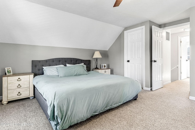 bedroom with lofted ceiling, ceiling fan, and carpet floors