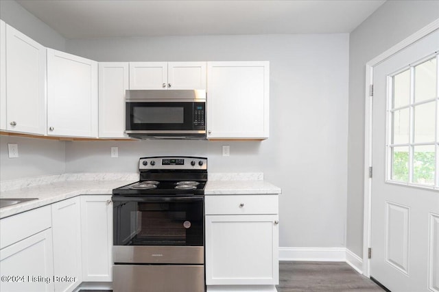 kitchen with white cabinetry, a healthy amount of sunlight, and stainless steel appliances