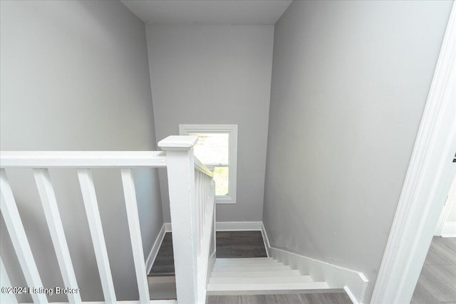 stairs with hardwood / wood-style flooring