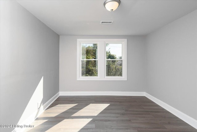 unfurnished room featuring dark hardwood / wood-style floors