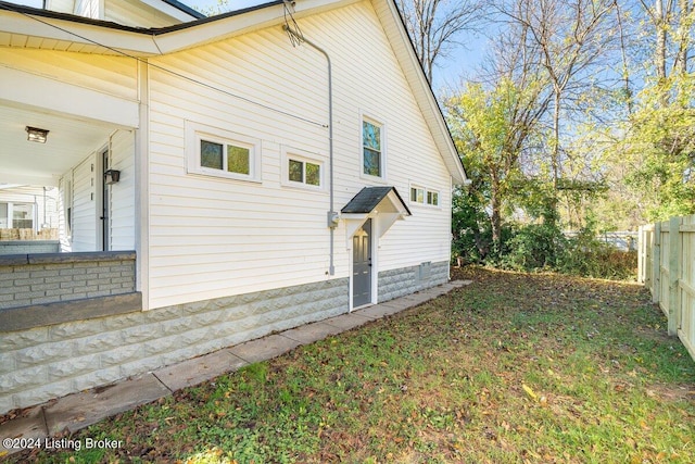 view of home's exterior with a yard