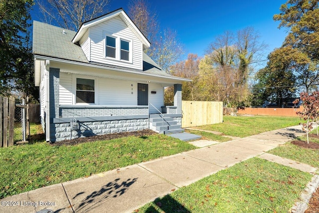 bungalow-style home with covered porch and a front yard