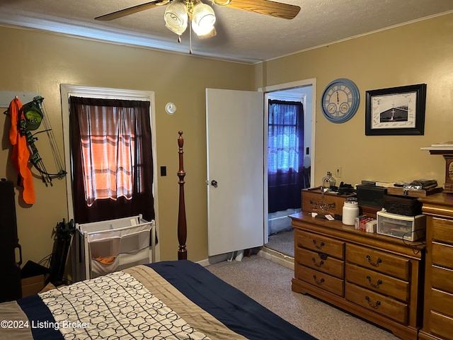 bedroom featuring ceiling fan and a textured ceiling