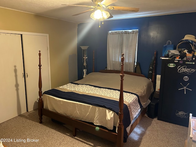 bedroom with carpet, ceiling fan, and a closet