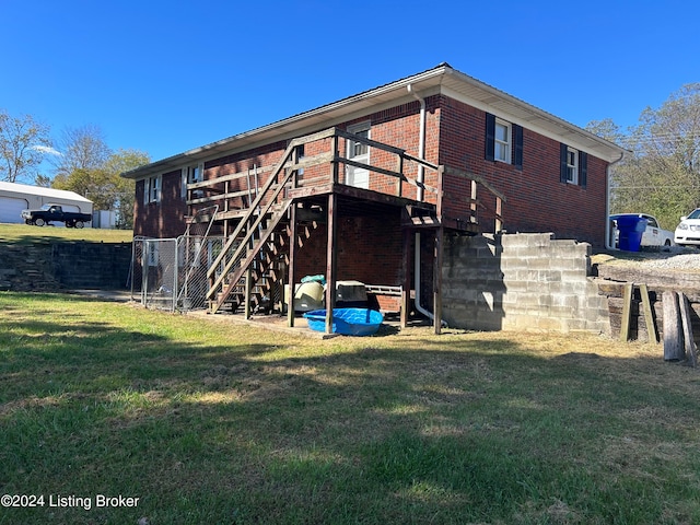 back of property featuring a yard and a deck