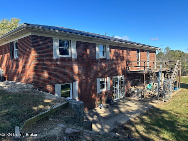 back of property featuring a deck