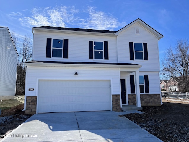 traditional-style home with concrete driveway, stone siding, and an attached garage