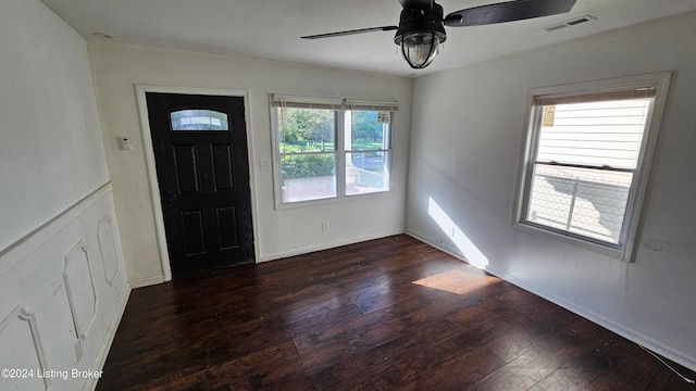 foyer featuring dark hardwood / wood-style flooring, ceiling fan, and a wealth of natural light