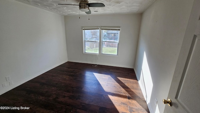 empty room with ceiling fan, a textured ceiling, and dark hardwood / wood-style flooring