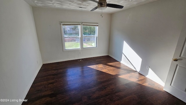 spare room featuring ceiling fan and dark hardwood / wood-style flooring