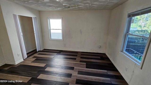 spare room featuring dark wood-type flooring