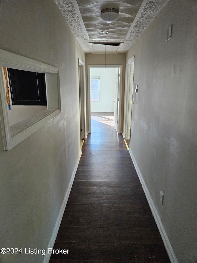 corridor featuring dark hardwood / wood-style flooring