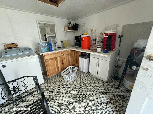 laundry area featuring washer / clothes dryer, a textured ceiling, and ornamental molding