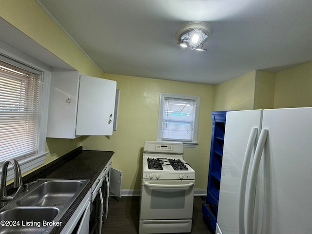 kitchen with white cabinets, white appliances, and sink