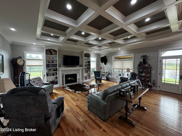 living room with ornamental molding, coffered ceiling, and wood-type flooring