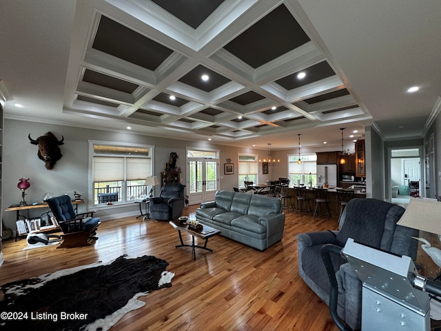 living room featuring beamed ceiling, ornamental molding, coffered ceiling, and wood-type flooring