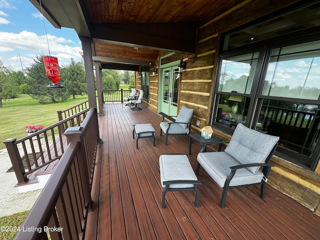 wooden terrace featuring a yard