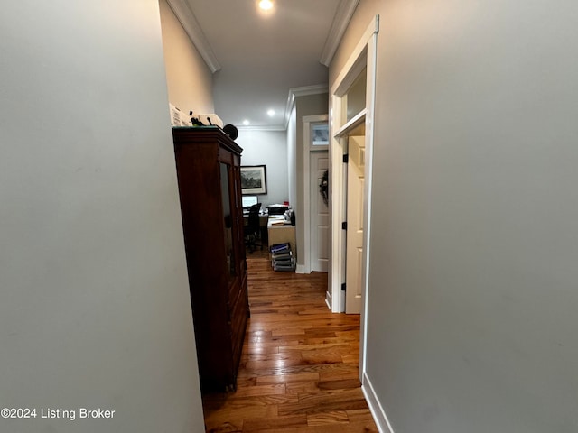 corridor featuring ornamental molding and dark hardwood / wood-style floors