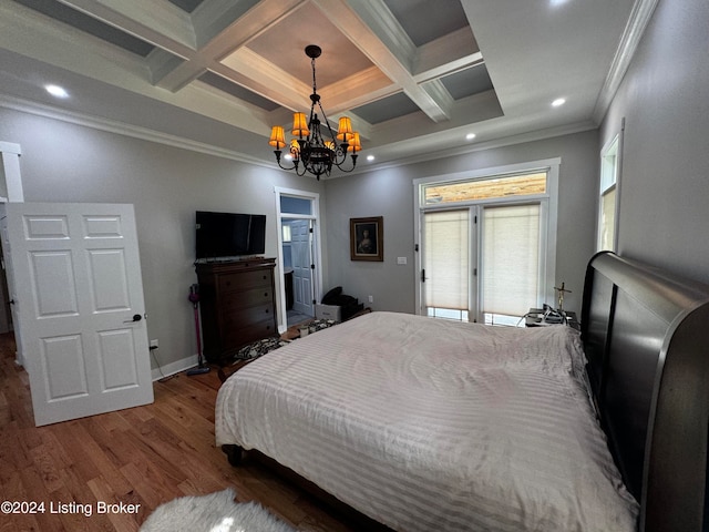 bedroom featuring crown molding, coffered ceiling, wood-type flooring, and a notable chandelier