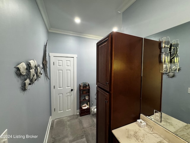 bathroom with ornamental molding and tile patterned flooring