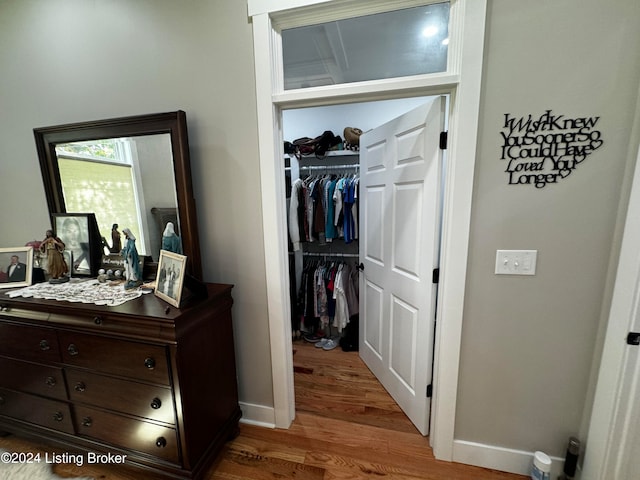 hall with hardwood / wood-style flooring