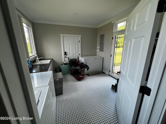 laundry area featuring ornamental molding, sink, electric panel, and separate washer and dryer