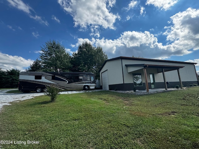 exterior space with a carport, a lawn, and a garage