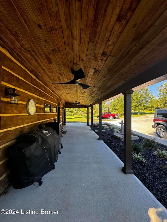 view of patio / terrace with ceiling fan and a carport