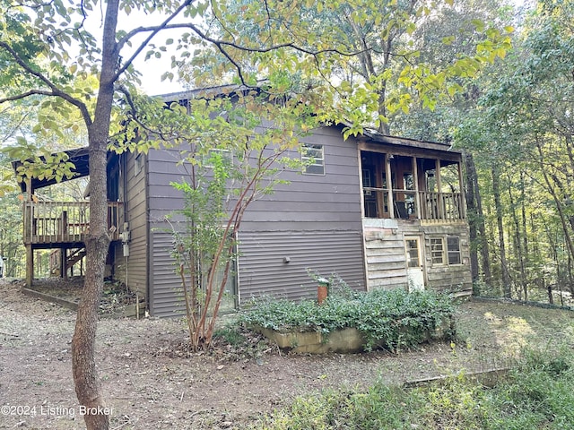 view of home's exterior with a wooden deck