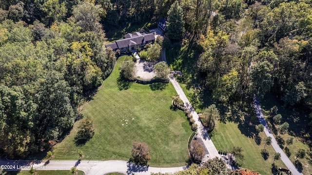 birds eye view of property with a view of trees