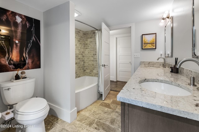 full bath featuring double vanity, shower / bath combo, a sink, and toilet