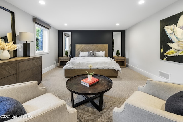 carpeted bedroom featuring recessed lighting, visible vents, and baseboards