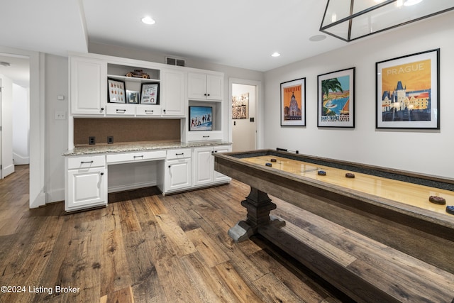 kitchen featuring visible vents, dark wood finished floors, white cabinetry, open shelves, and built in desk