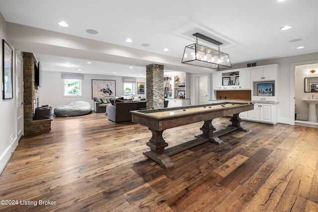 rec room featuring recessed lighting, visible vents, decorative columns, and hardwood / wood-style floors