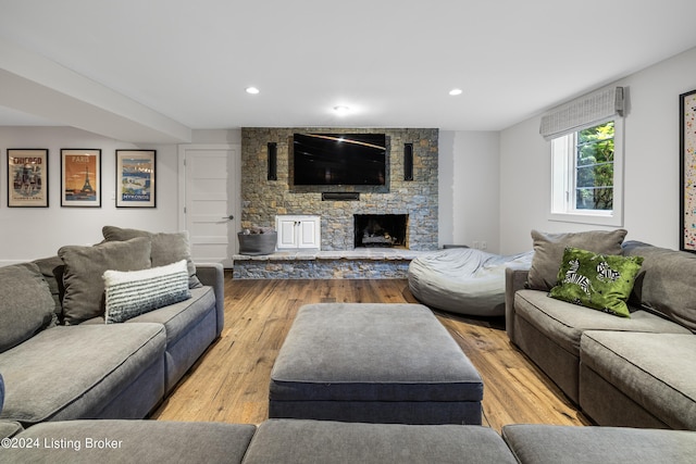 living area with a fireplace, wood-type flooring, and recessed lighting