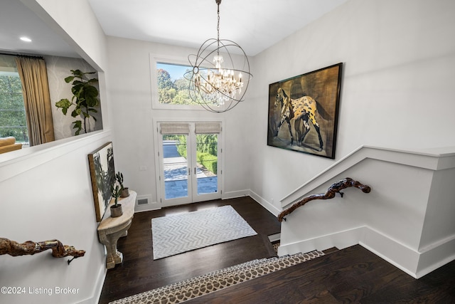 entrance foyer with wood finished floors, a wealth of natural light, and baseboards