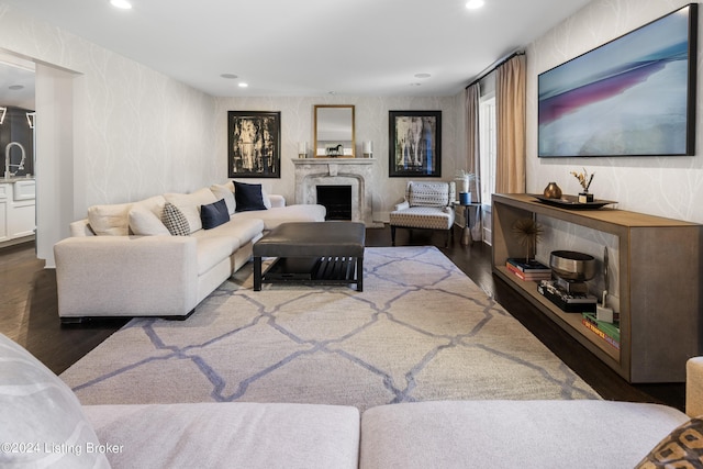 living room featuring a high end fireplace, recessed lighting, and wood finished floors