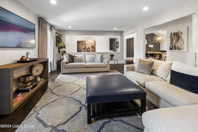 living area with recessed lighting, wood finished floors, and a notable chandelier