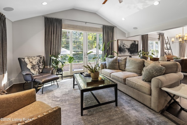 living room featuring recessed lighting, ceiling fan with notable chandelier, wood finished floors, baseboards, and vaulted ceiling