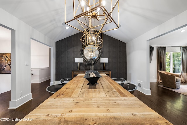 dining space with dark wood finished floors, visible vents, an accent wall, vaulted ceiling, and baseboards