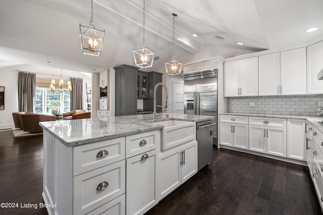 kitchen featuring dark wood-style flooring, vaulted ceiling with beams, decorative backsplash, appliances with stainless steel finishes, and a sink