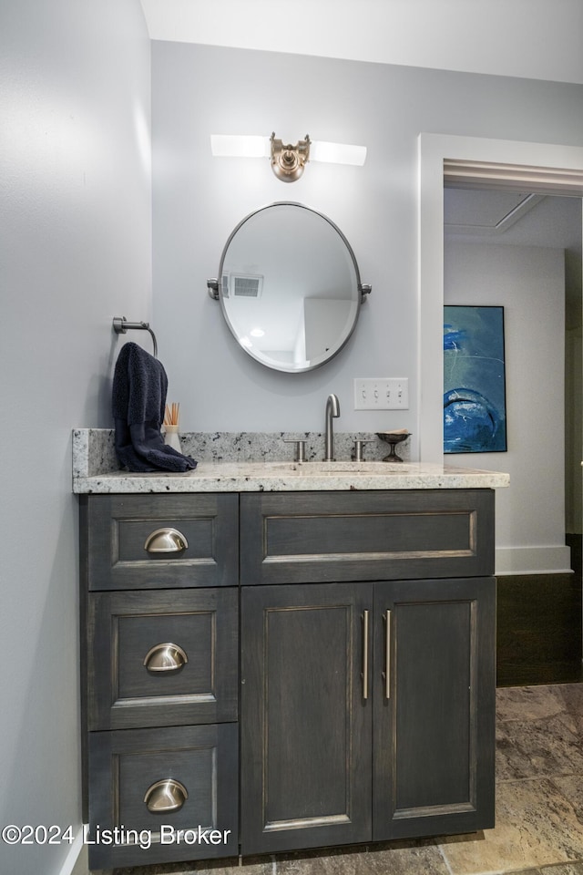 bathroom with visible vents, vanity, and baseboards