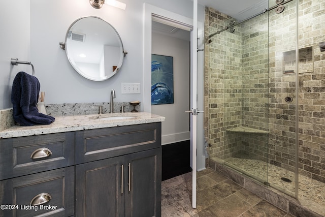 full bathroom featuring baseboards, visible vents, a shower stall, and vanity