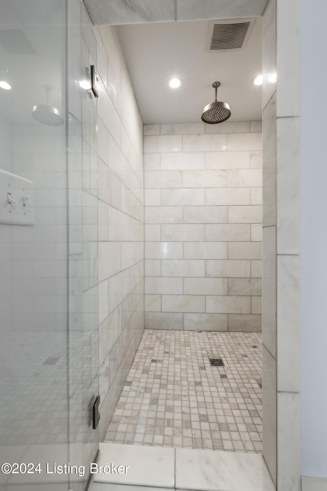 full bath with a stall shower and visible vents