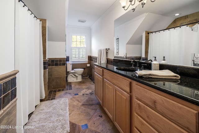 bathroom featuring wainscoting, toilet, a shower with curtain, vanity, and tile walls