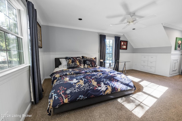 bedroom with ornamental molding, carpet, a wainscoted wall, and lofted ceiling