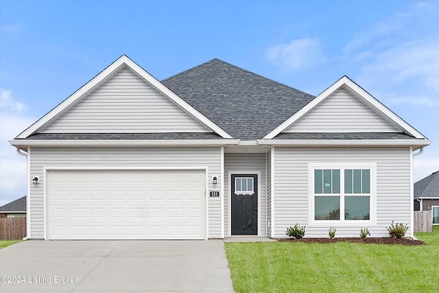 view of front of home with a front lawn and a garage