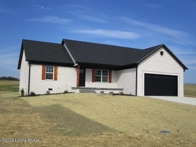 view of front of home with a front lawn and a garage