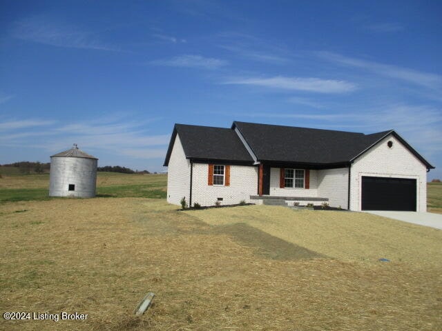 view of front of home with a front yard and a garage