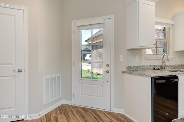 doorway to outside with light hardwood / wood-style floors and sink